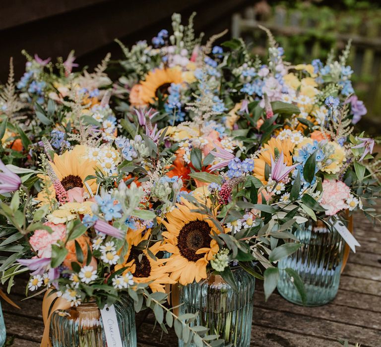 Pastel wedding bouquets with sunflowers with simple buttonholes 