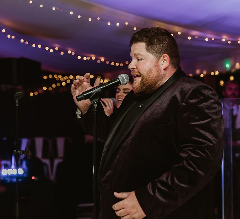 Wedding singer performs at wedding reception 