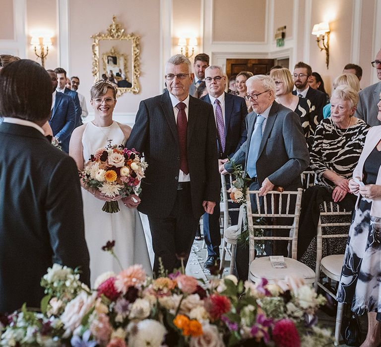 Father of the bride walks bride down the aisle at Bowcliffe Hall wedding with autumnal colour palette 