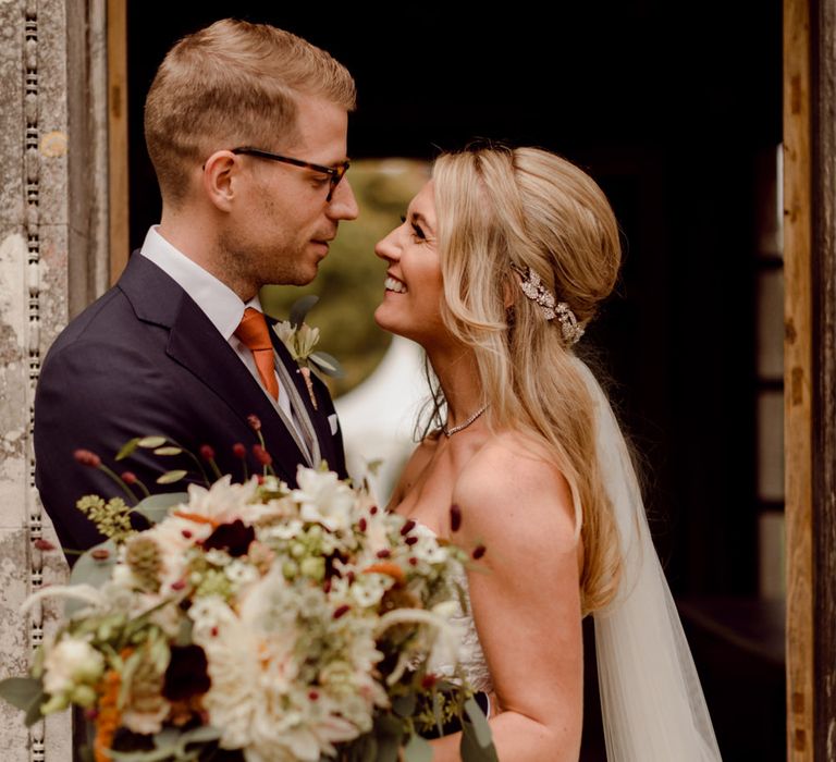 Bride and groom at Larmer Tree Gardens wedding with gorgeous bouquet