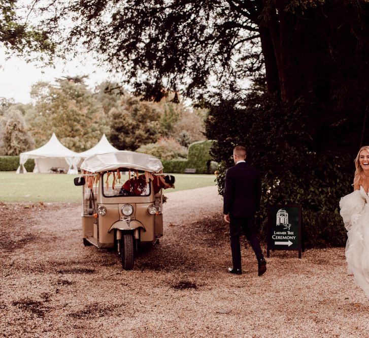 Bride and groom make their way to dinner at Larmer Tree Gardens Wedding