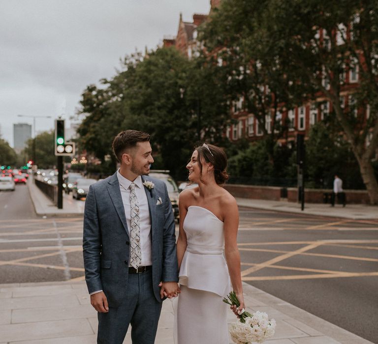 Bride in Roland Mouret wedding dress and groom in blue suit