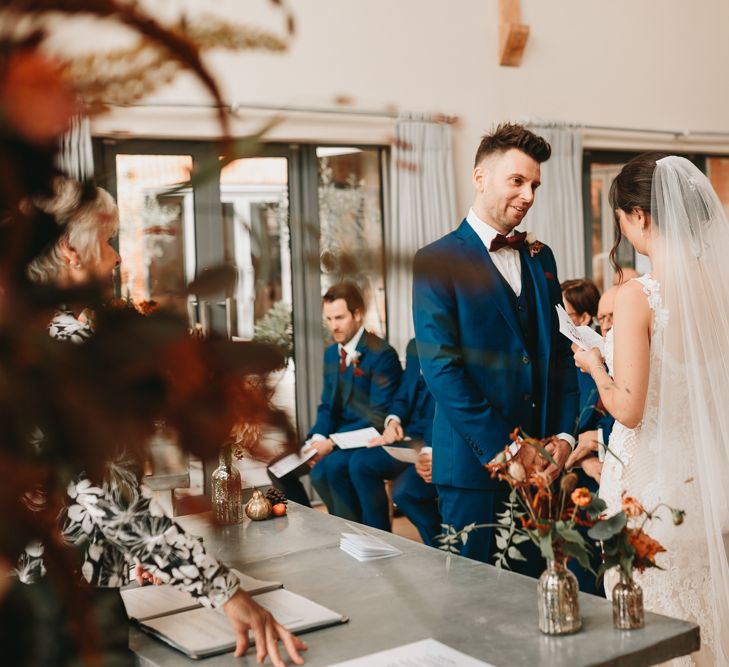 Bride and groom exchanging vows at Millbridge Court wedding