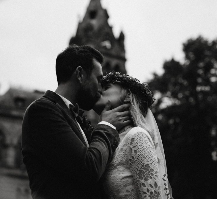 Black and white portrait of bride and groom kissing in Chester Town