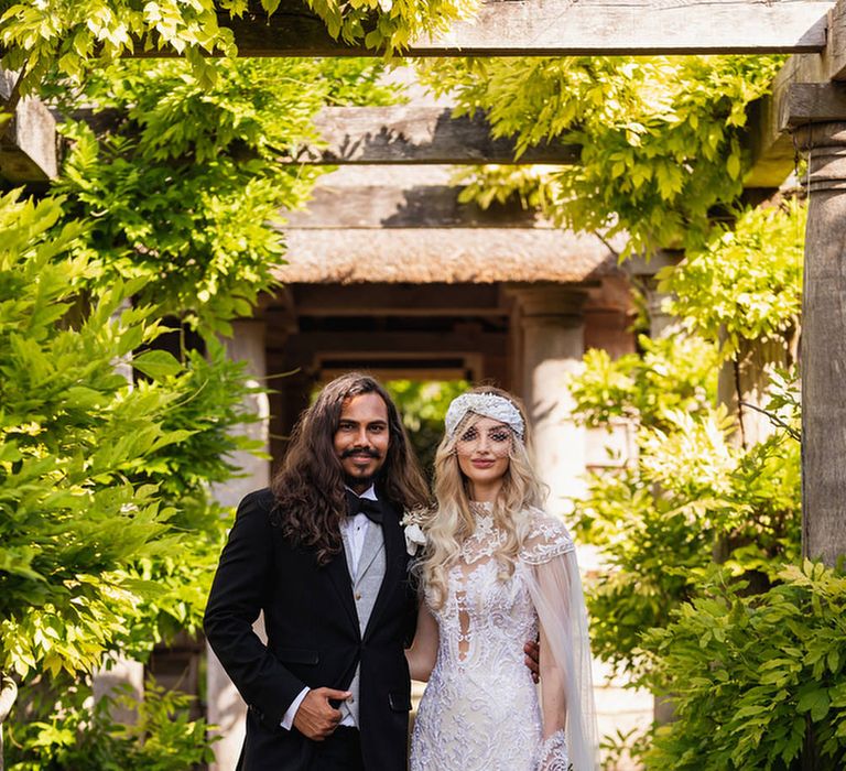 Stylish bride and groom in black suit and Wona Concept wedding dress at The Lost Orangery 