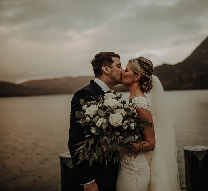 Bride and groom on their wedding day with stunning Lake District