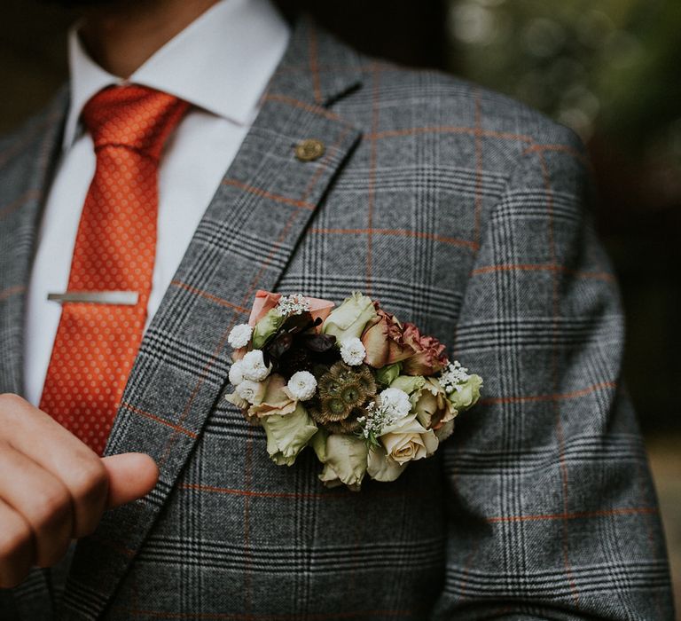 Unique grooms buttonhole with autumn flowers 