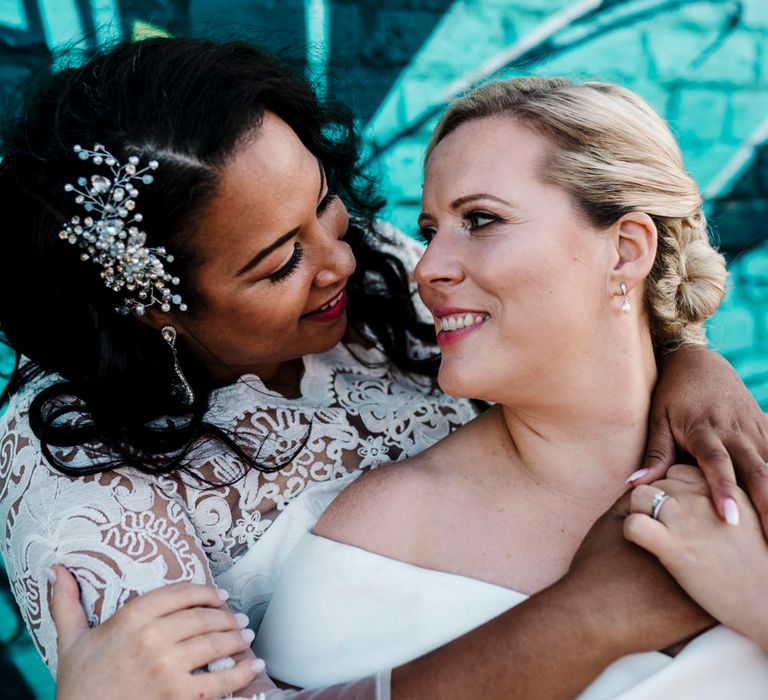 Stunning lesbian couple on their wedding day in Liverpool with graffiti backdrop 