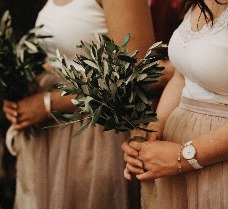 Bridesmaids hold olive bouquets