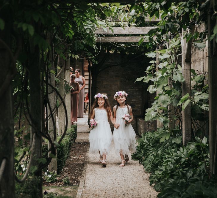 Flower girls run down path at The Tythe barn