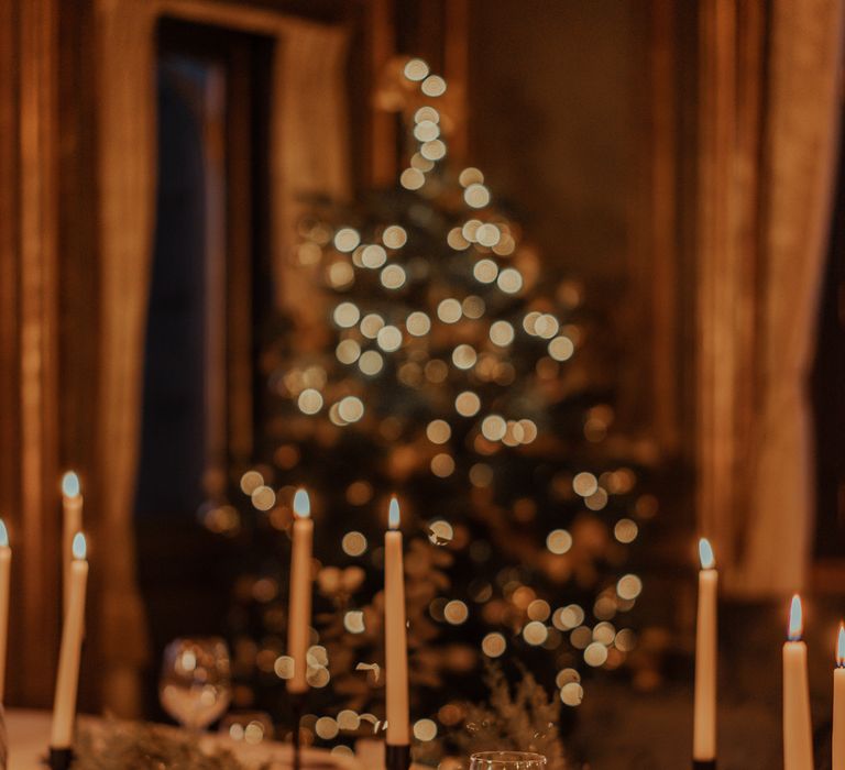 Christmas tree behind table setting at Cliveden House