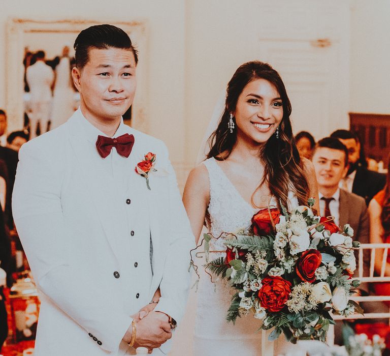 Bride & groom smile during their wedding ceremony