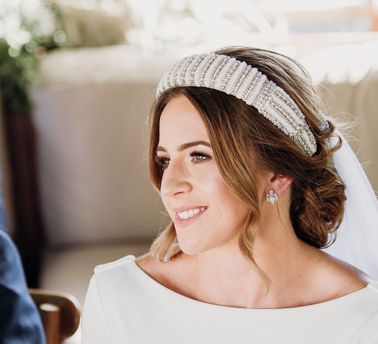 Smiling bride in Elbeth Gillis gown and beaded bridal headband at Euridge Manor wedding ceremony