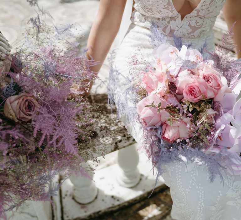 Bride holds bouquet with pastel pink roses 