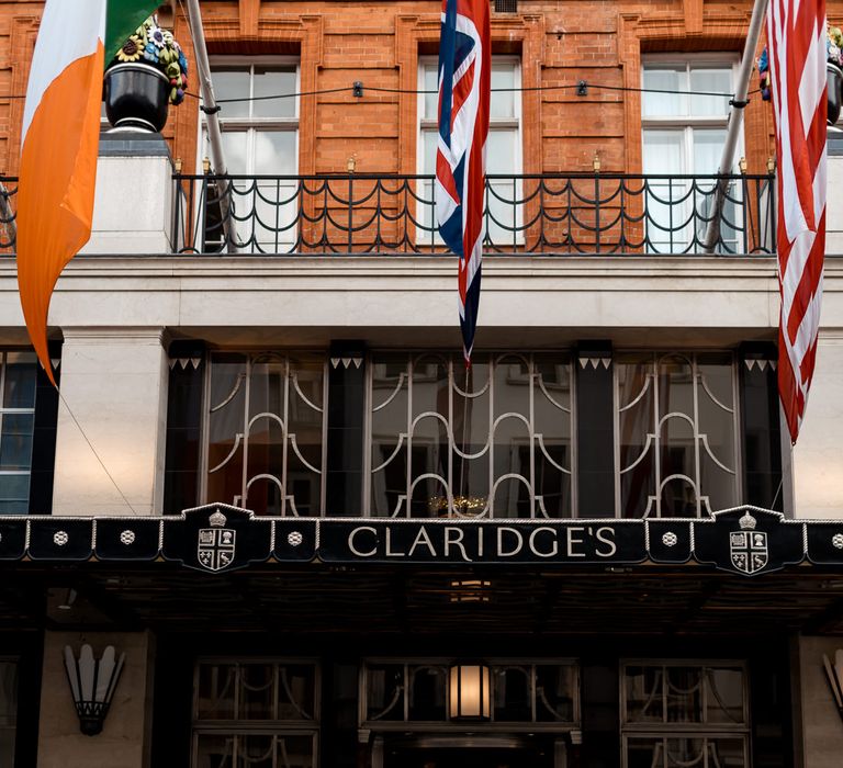 Bride and groom standing outside Claridge's 