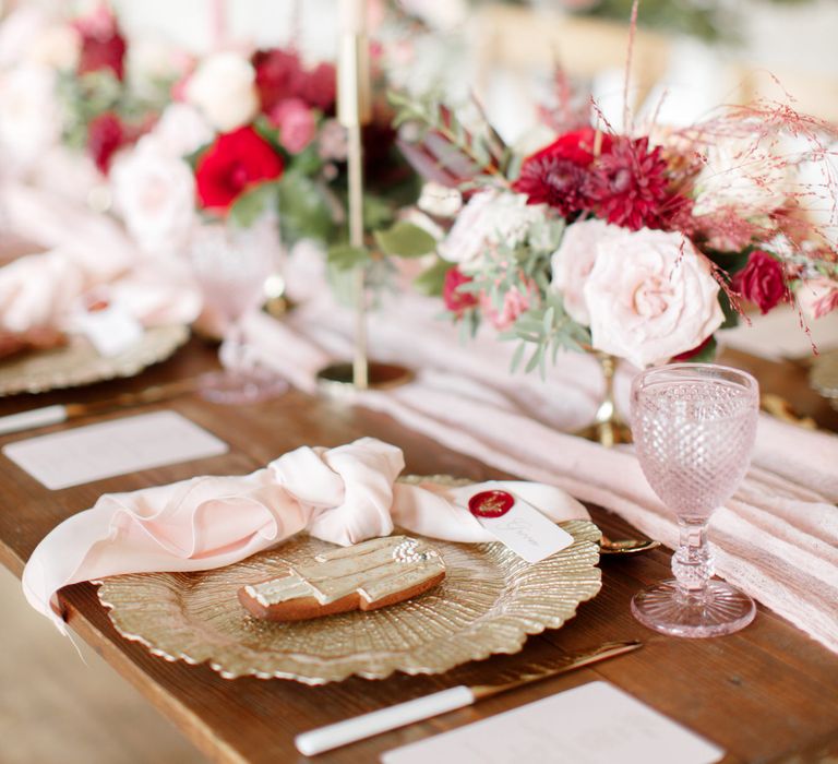 Table decor with golden plate and pale pink glassware 