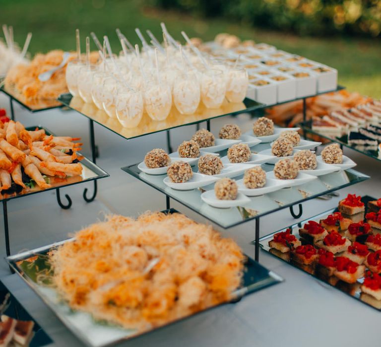 A table of canapes in orange and red hues