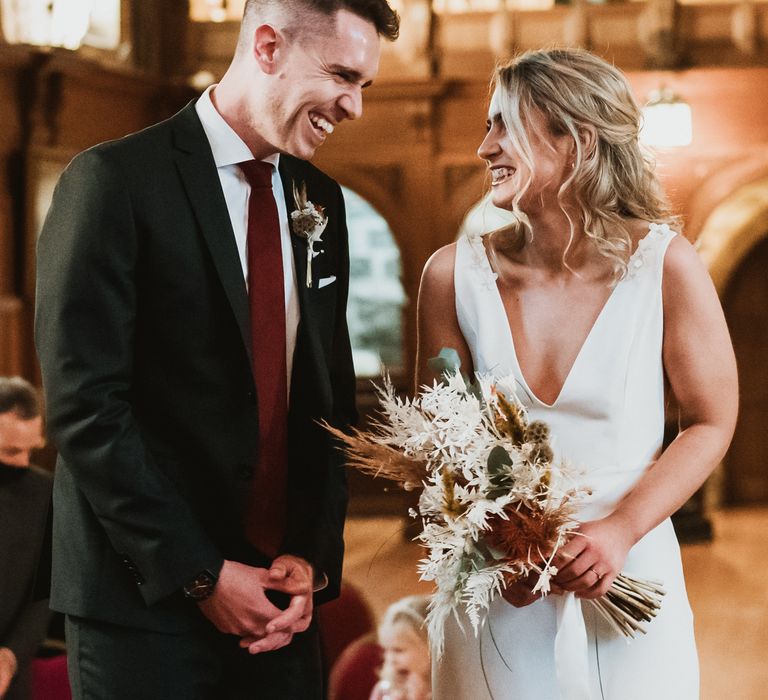 Bride & groom look at one another during their wedding ceremony