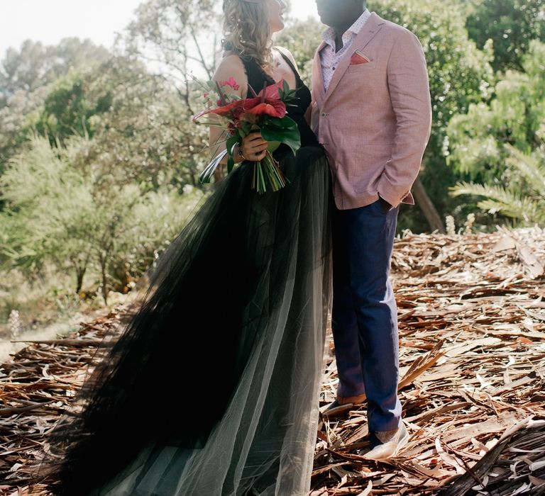 Tropical flower bouquet for bride in Vera Wang black wedding dress