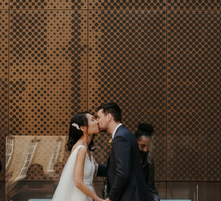 Bride and groom kiss as they get married