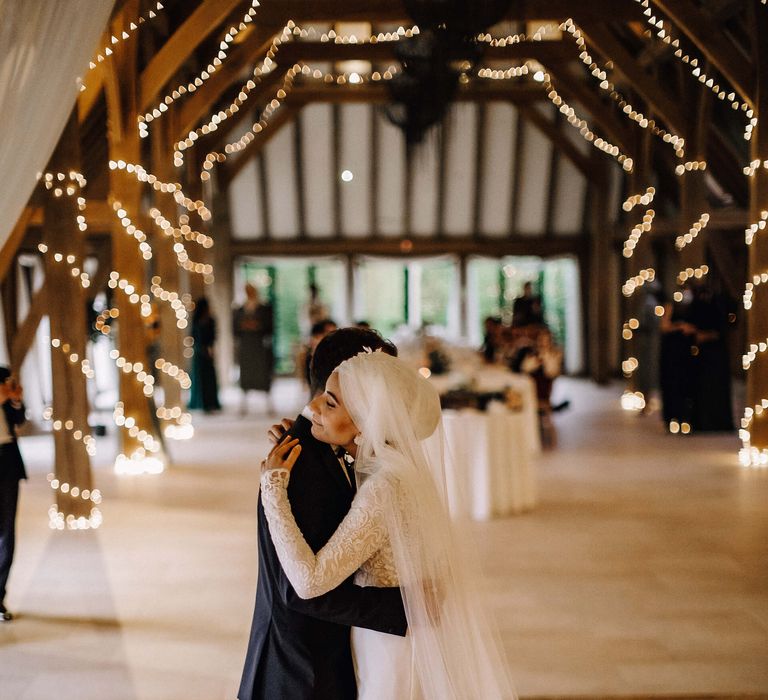 Bride and groom share their first dance together in Old Kent Barn wedding venue