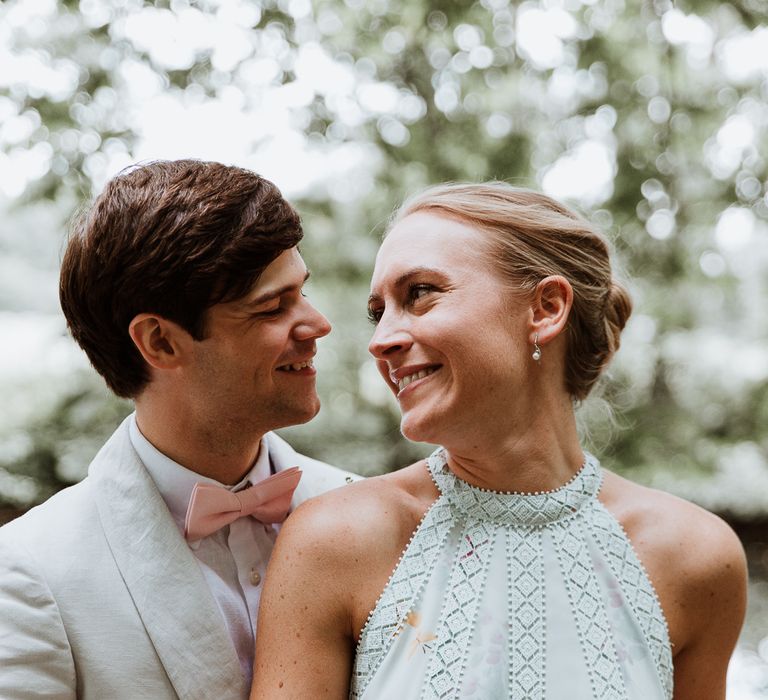 Bride & groom look lovingly at one another on the day of their wedding