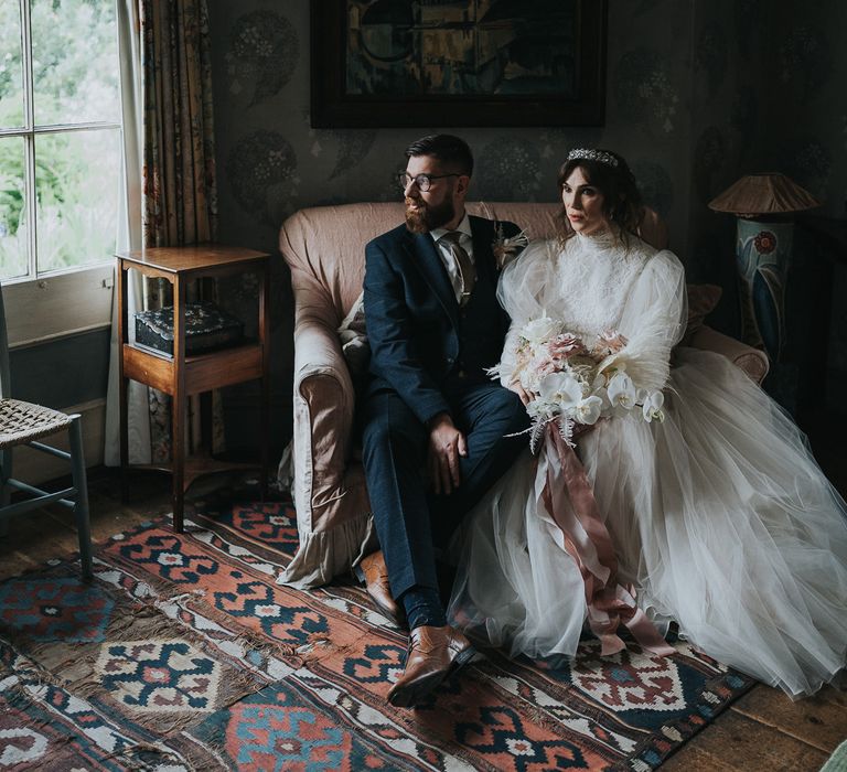 Bride & groom sit with one another on their wedding day