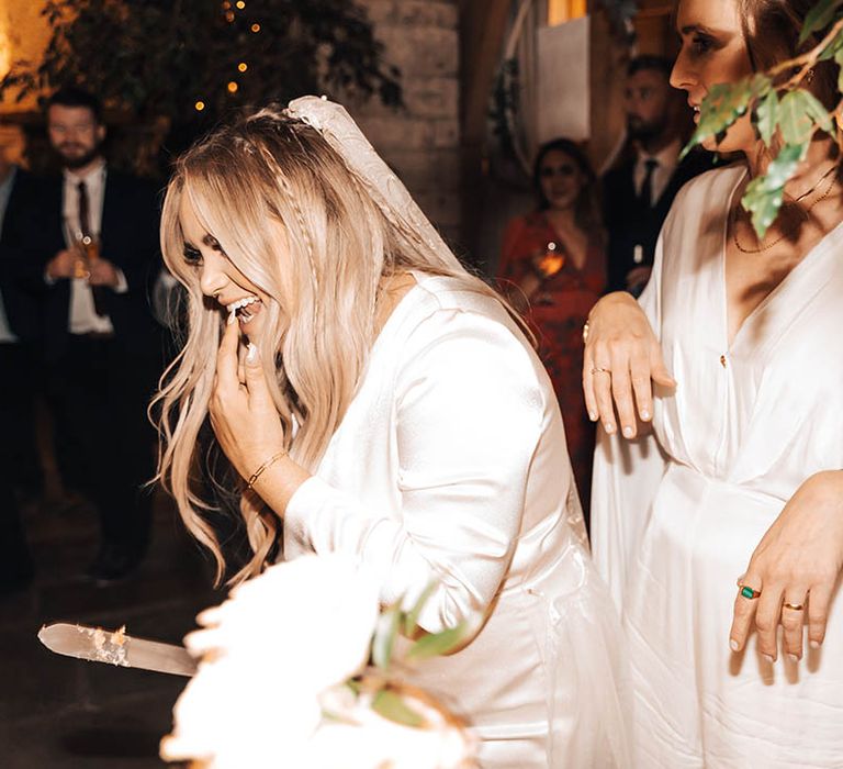 Bride tries wedding cake after cutting on her wedding day