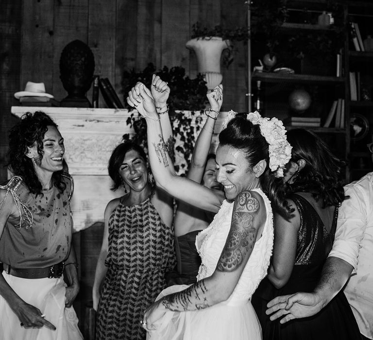 Bride dances on her wedding day during reception in black & white image