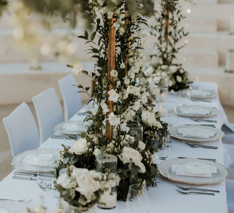 Beautiful floral installations in the middle of classic white table for reception dinner | Hannah MacGregor Photo & Film