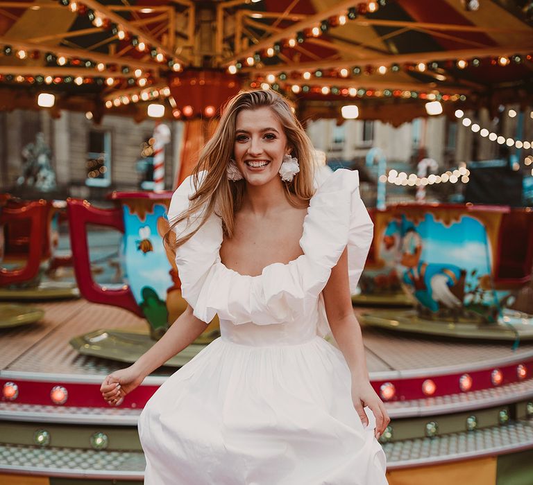 Bride in an organza wedding dress with ruffle collar and layered skirt