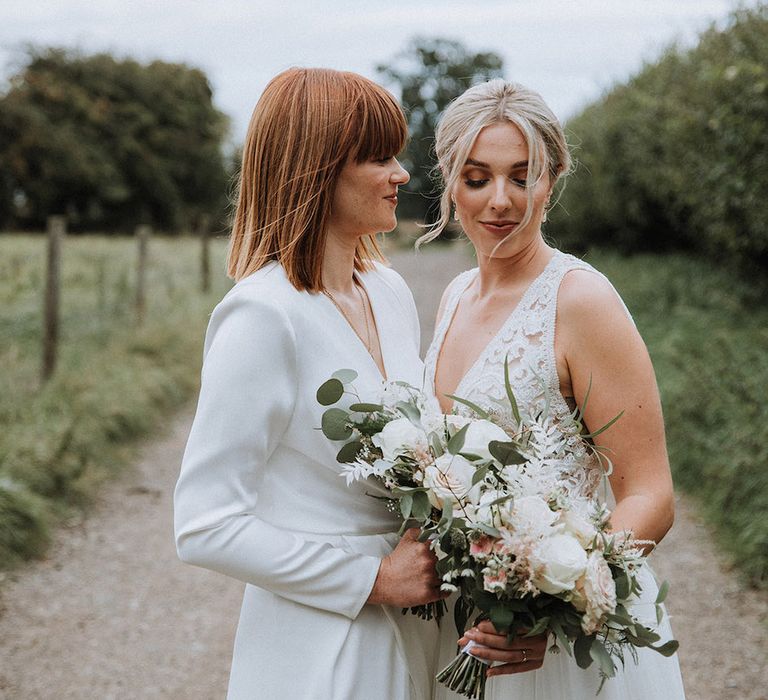 Lesbian wedding at The Great Tythe Barn wedding venue with blush bouquets