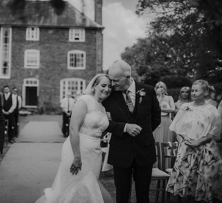 Father of the bride giving his daughter away at an outdoor wedding ceremony at Dewsall Court 