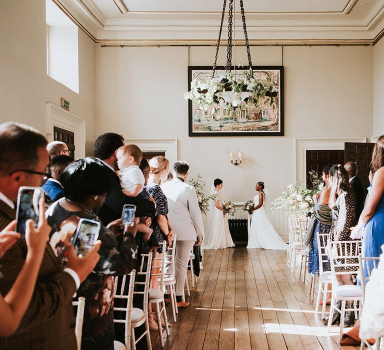 Two brides exchanging personalised vows at their civil wedding ceremony 