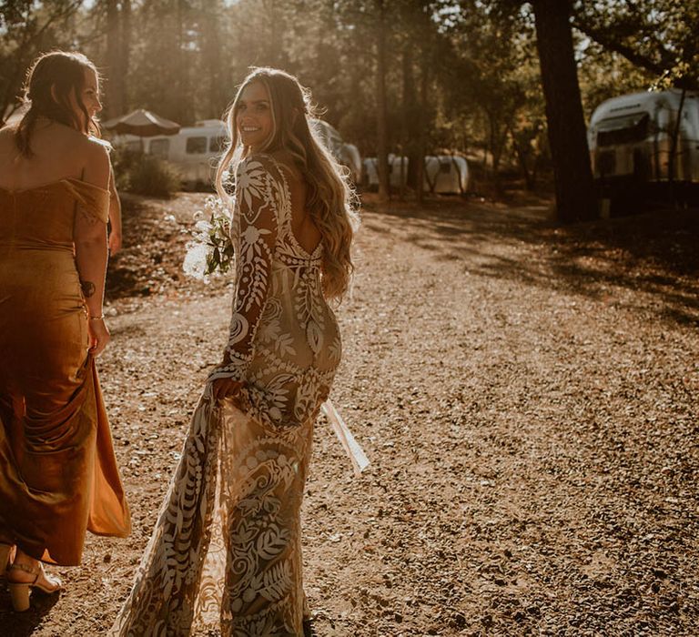 Bride walks with bridesmaid on her wedding day