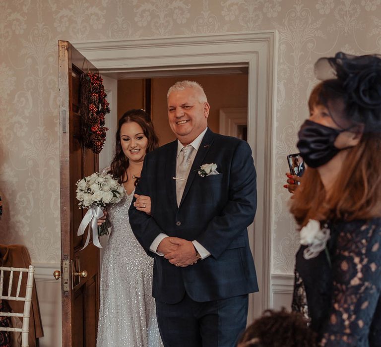 Bride walks down the aisle with her father