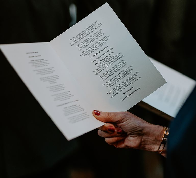 Wedding guests holds hymns on wedding day