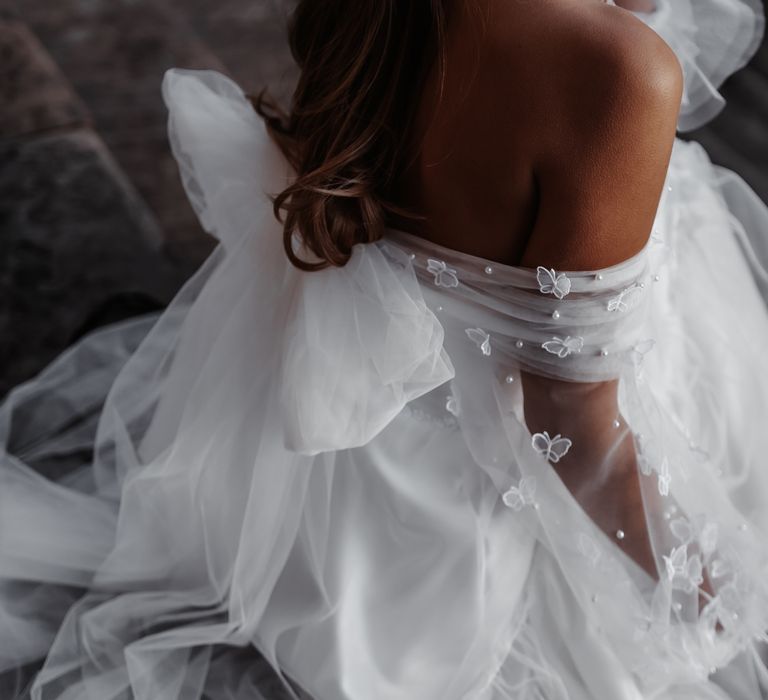 Off the shoulder wedding dress with tulle bow on the back complete with pearls and 3D butterflies 