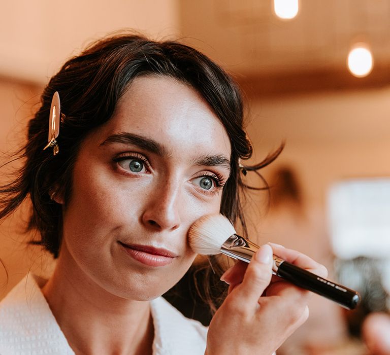 Bride gets makeup done for her wedding day