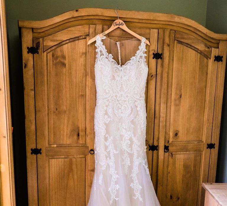 Lace wedding dress with mermaid tulle skirt on hanger 