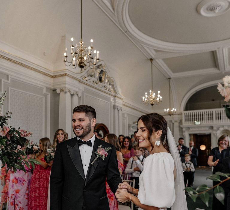 Bride and groom standing at the alter at stylish modern Somerset House venue