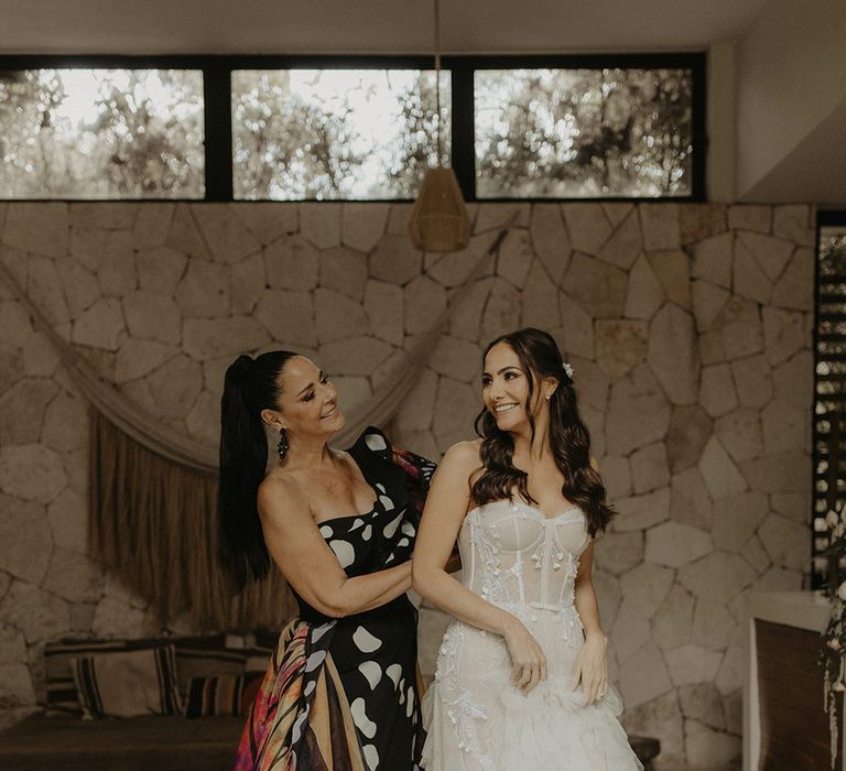 Bride wears corset styled wedding dress with ruffled skirt for cenote wedding Tulum