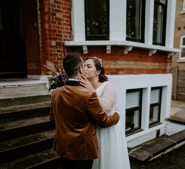 The couple share a kiss at home before attending their London wedding ceremony