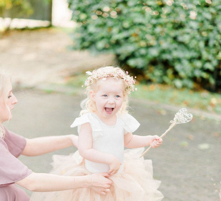 Flower girl wears pastel peach tutu and white Dr Martens with pink silk ribbon laces