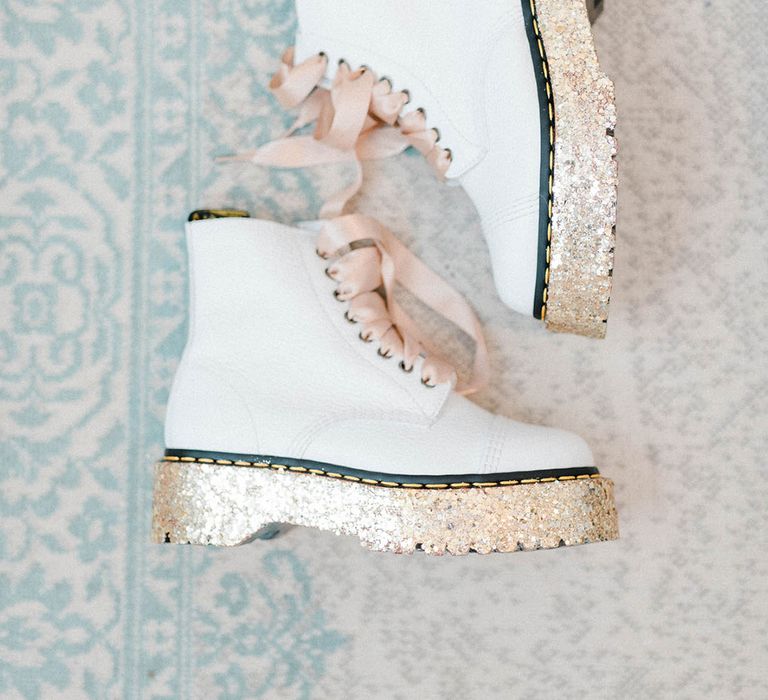 White Dr Martens finished with pink ribbon laces and sparkly heels 