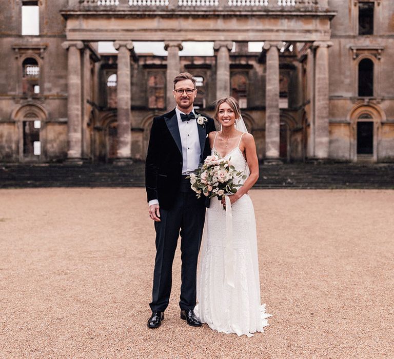 Hanley Hall Worcestershire wedding venue with the bride in a fitted lace wedding dress with the groom in a black tuxedo 