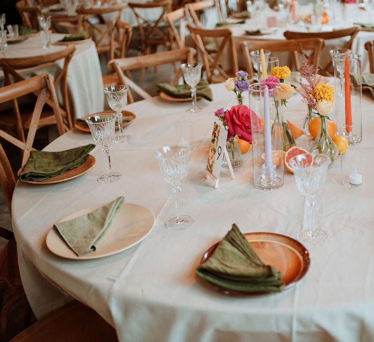 colourful wildflowers, taper candles and fruit centrepiece decoration