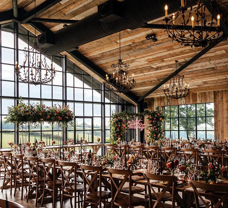 The Barn at Botley Hill wedding venue with iconic windows with blue and copper theme with flower columns, neon sign and disco balls 