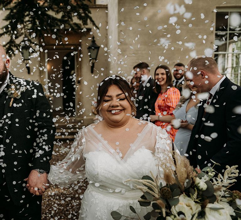 Fun confetti exit for the bride and groom after their intimate wedding ceremony 