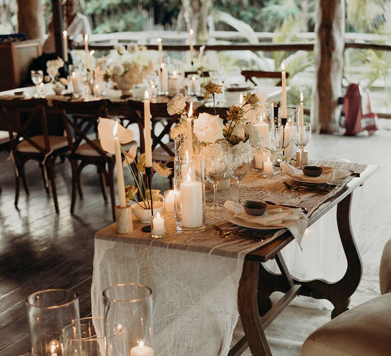 intimate sweetheart table at Mexican wedding with white anthurium wedding flowers and candle table decorations 